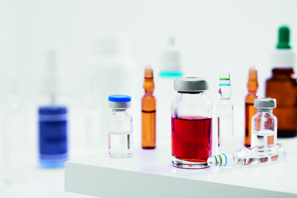 closeup-shot-different-glass-vials-with-liquids-white-surface-lab.jpg